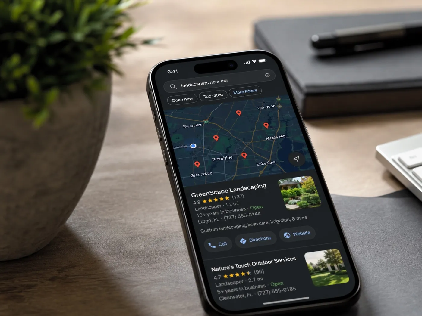 Local 'landscapers near me' search results on a phone with a landscaping company ranking at the top