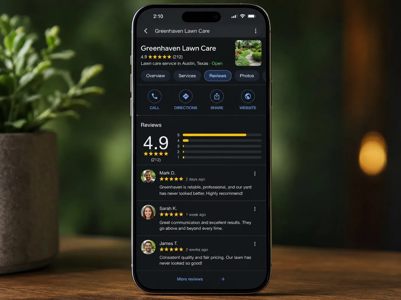 A phone showing a stream of five-star Google reviews for a lawn care company